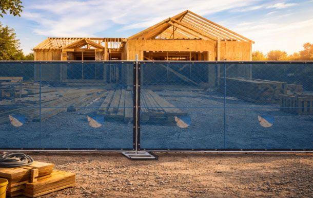 Temporary fence panels wrapped in a privacy screen cover